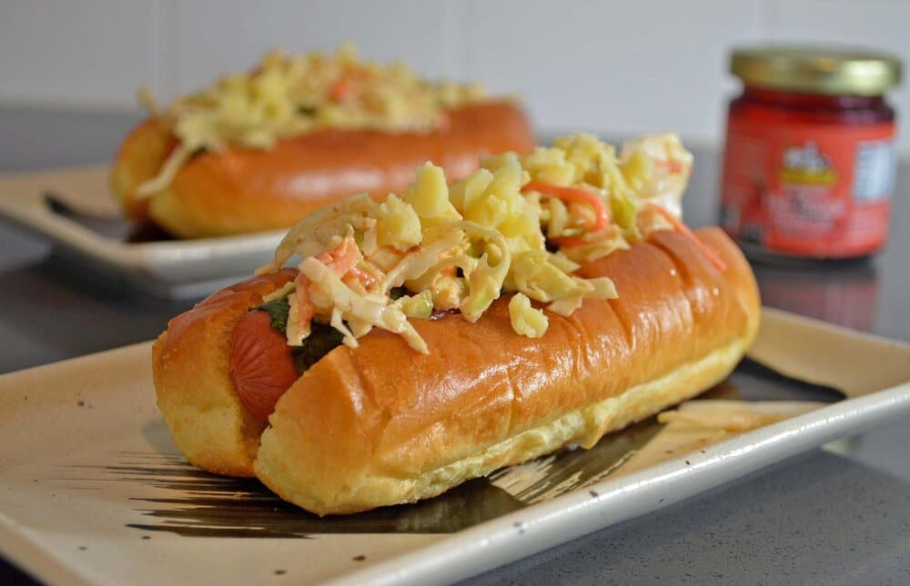 Grilled mint-wrapped hot dog topped with Mama Lam’s spicy slaw