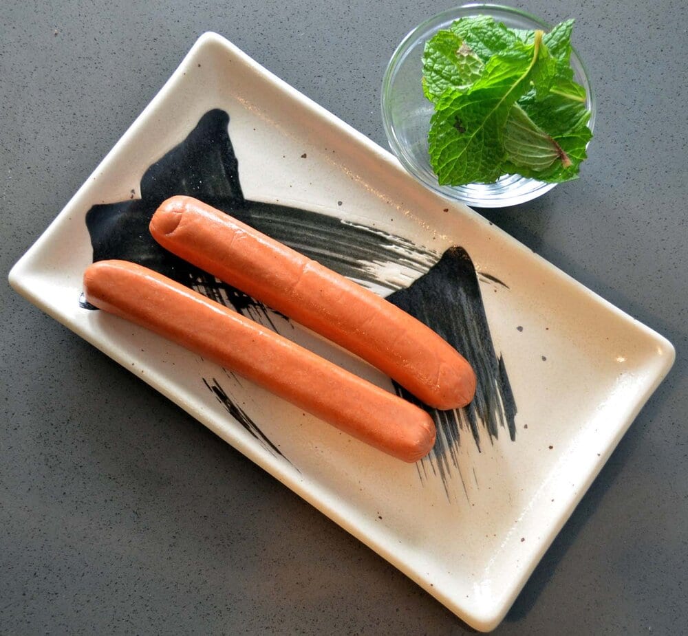 Hot dog links and washed mint leaves